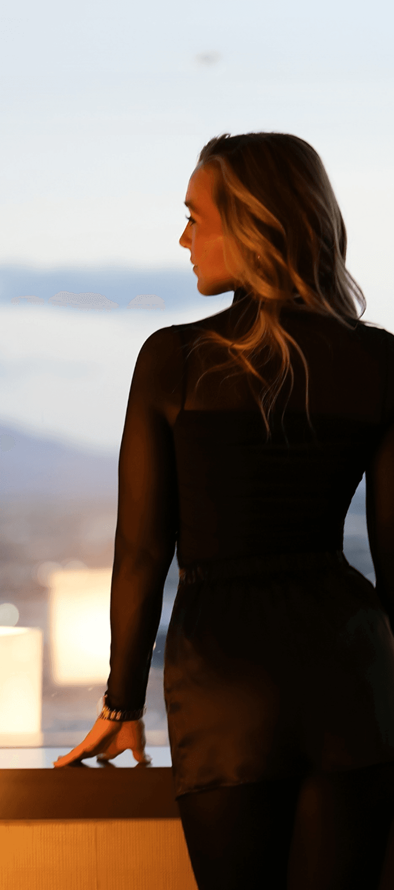 Laurin standing against a dramatic backdrop